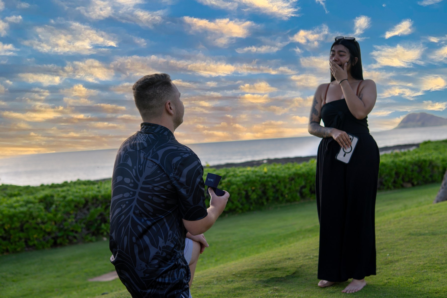 Breckin proposing to Tehani by the ocean at sunset
