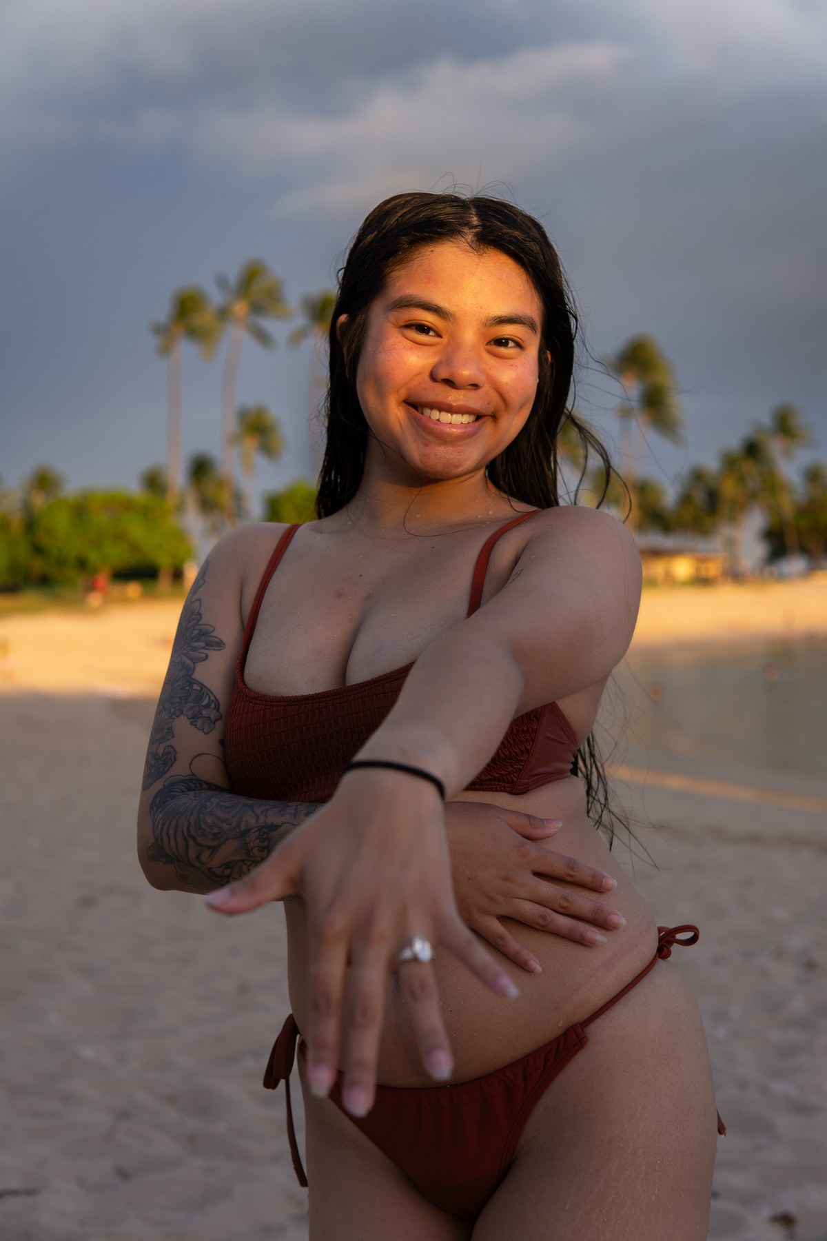 Tehani showing her engagement ring on a Hawaiian beach